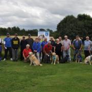 REELING IN THE FUNDS: Marie Court with other Guide Dog volunteers and fishing contestants.