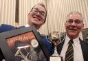 Oliver Wilson (Musical Director) and Roland Deaking (Bass player) with the trophy from the Wychavon Festival.
