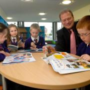 NEW LOOK: Headteacher Martin de Vine with year seven pupils, from left, Lottie Davies, Amy Wright, Alex Reeve and Jamie Griffin in the refurbished library. Picture: 121407L