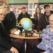 Students Summer Bowen, Harry Gardiner, Rebecca Philpotts and Ben Jevons tell Lions president Ron Cross and Lions treasurer and secretary Linda Cross about the expedition