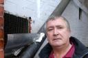 ODOUR COMPLAINT: Adrian Mayall standing next to the extractor fan he is complaining about.