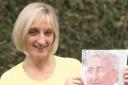 Marathon tribute: Carole Jones with a picture of her late father-in-law, Roy Jones. Buy photo: 421020J