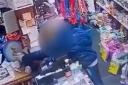 CCTV footage shows a charity collection box being taken from a shop