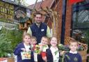 Matt Morgan picured with allotment club pupils who were presented with seeds and plants following their visit.