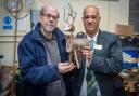 Peter Lloyd (left) at Bromsgrove Men in Sheds showing Barratt Homes sales adviser Tony Din (right) a woodwork Rudolph