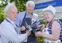 Getting heated: From left, David Wase, chairman of the League of Friends, Peter Picken and Fran Oborski prepare for the barbecue.