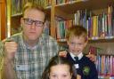 STORY TIME: Luke Temple with Burlish Park pupils Eden Troth and Joseph Butler, both aged 7.