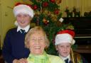 CHRISTMAS CHOIR: Burlish Park pupils Harriet Ferris, and Aimee Hartin with centre visitor June Whiteman-Haywood.