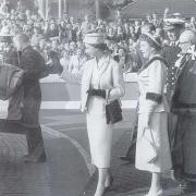 The Queen waves to crowds
