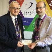 Kidderminster and District Lions Club president Ron Cross presents £900 to Baxter College DofE manager Andrew Macpherson