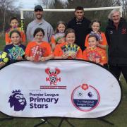 St Bart’s girls’ football team with Harriers’ players Shane Byrne and Christian Oxlade-Chamberlain and community sports manager Nick Griffiths