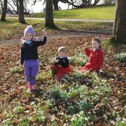 Snow joke: From left, Isabella Kennedy, 5, Oscar Niblett, 6 and Lucy Underwood, 7, on the snowdrop hunt at Abberley Hall School.