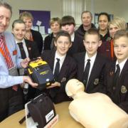Life saving: Manager of Sainsburys Kidderminster Kevin Healey hand the defibrillator over to Wolverley Secondary School staff and pupils. Photo: Phil Loach. 081309L.