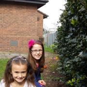 SOWING SEEDS: Back, Anna Howard and Alice Hatfield plant poppies in the grounds the Holy Innocents' Church.