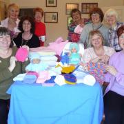 Club members celebrate a day of practical action with the finished items