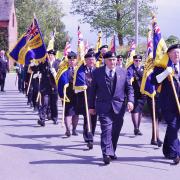 MARCHING ON: The parade through Rock was led by 21 standard bearers of Royal British Legion branches from across Worcestershire and Shropshire.