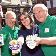 FUNDRAISERS: Phil Wright and Pete Doncaster of Wyre Forest CAMRA with Debbie Broomfield of Kemp Hospice with pump clips that will be sold to raise funds. Photo COLIN HILL.