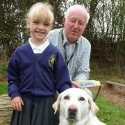 SURPRISE VISIT: Burlish Park pupil Grace Heeley, aged 5, and trainer Brian Lawrence with Crumble.