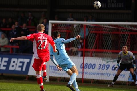 Anthony Malbon unleashes his volley for Harriers' goal.