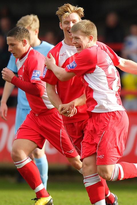 Anthony Malbon celebrates his goal with Kyle Storer and Ryan Rowe.