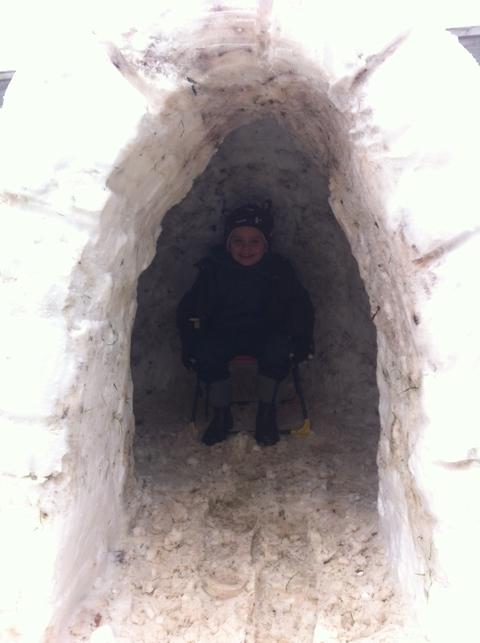 Charlie Edwards sat inside an igloo built by Jay Sargent and Mickey Sargent. Photo: Sarah Brooks.