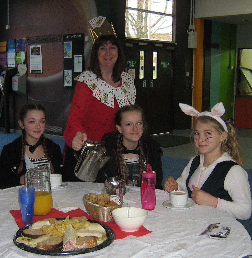 Wolverley CE Secondary School assistant headteacher, Sheena Howard, serving students at the Mad Hatters Tea Party
