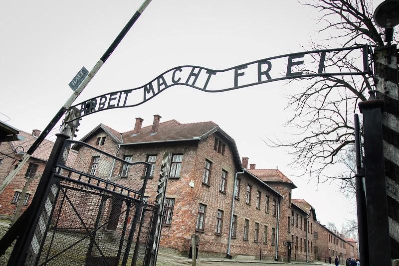 An archway at Auschwitz 1, displaying a phrase which translates in English as "work sets you free". Photo by Yakir Zur
