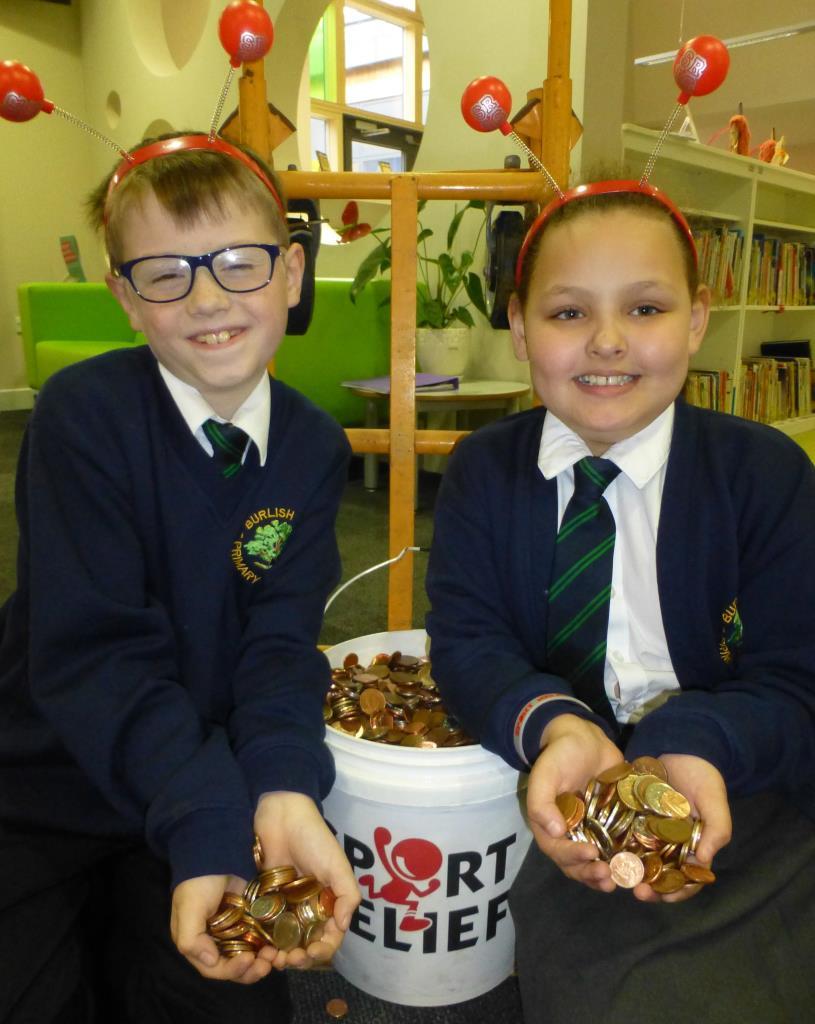 Luke Modley, nine, and Megan Gowdy, eight, from Burlish Park Primary School, with the money raised for Sport Relief
