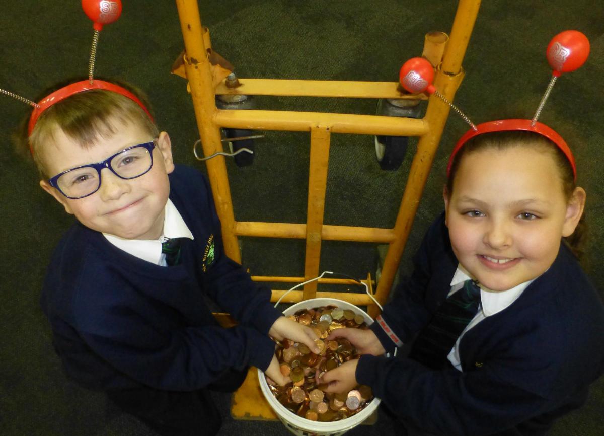 Luke Modley, nine, and Megan Gowdy, eight, from Burlish Park Primary School, with the money raised for Sport Relief