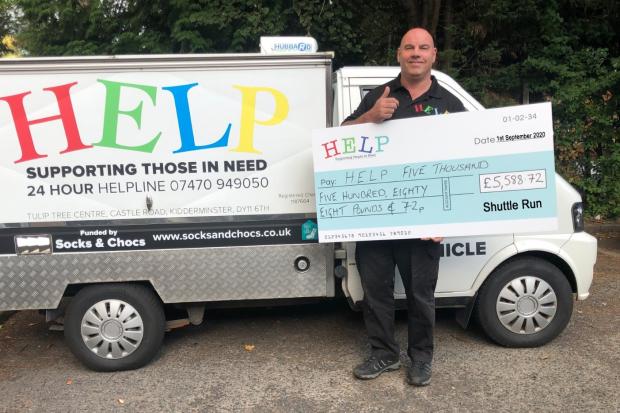 HALFWAY: HELP founder Dave Griffin with a cheque for £5,000 from the Shuttle Run Appeal