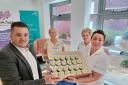 Digital Advertising Consultant Andrew Preece from The Shuttle hands over the cakes at Kidderminster Hospital to mark the NHS 75th anniversary