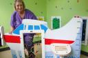 Ward manager Sally Bloomer with the standalone aeroplane which forms part of the new interactive waiting room