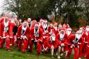 A group of Santa fun run participants get ready to run