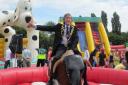 YEE HAA: Mayor of Kidderminster Mike Price taking a ride on the rodeo bull.