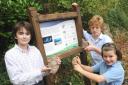 Time unravellers: Abberley Hall pupils with one of the fossils found on their school site and the information board. From left, Samuel Allen, 10, Tristan Lywood, 12 and Poppy Underwood, 9.