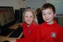 Logging on: Sytchampton Endowed First School pupils Rhianna Dunn and William Johnston-Hubbold, both aged seven.