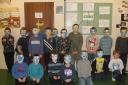 Beaver Scouts wearing their death masks they made