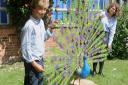 Model, pupils: Abberley Hall head boy Lucien Whitworth and head girl Lili Ismail with the sculpted peacock.