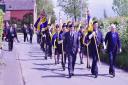 MARCHING ON: The parade through Rock was led by 21 standard bearers of Royal British Legion branches from across Worcestershire and Shropshire.