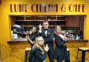 James Bond poses with bar staff