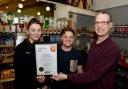 Manager Josh Barnes (centre) with CAMRA's Rob Budworth (right) and staff member Sophie Poultney.  Photo courtesy of Colin Hill.