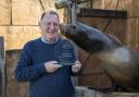 West Midland Safari Park’s Managing Director, Chris Kelly, celebrates winning Large Visitor Attraction of the Year, with sea lion, Jack.