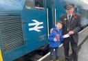 Young fundraiser Jacob Holden with Kidderminster station master Geoff Smith