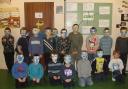 Beaver Scouts wearing their death masks they made