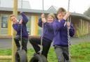 MONKEYING AROUND: From left, Cookley pupils Joey Swift, Eva Cook and Billy Davies try out the new playground.