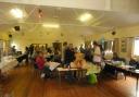 FUNDRAISERS: Visitors and stalls at the event in Clows Top Village Hall raising money for Vasculitis UK.