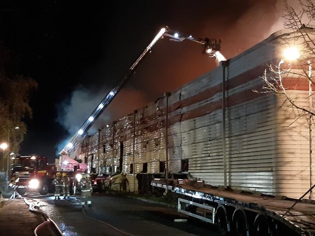 BLAZE: Firefighters use an aerial ladder to help try to bring the fire under control overnight. (Picture: Simon Cusack @HWFireSCusack)