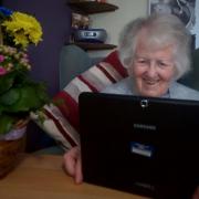 A care home resident video calling with family during the coronavirus lockdown