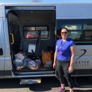 Baxter College assistant principal Katie Beech loads the minibus with food hampers