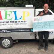 HALFWAY: HELP founder Dave Griffin with a cheque for £5,000 from the Shuttle Run Appeal